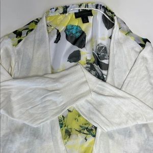 Woman’s white and shear floral print backed , front draped sweater